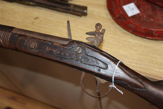 A Continental brass mounted flintlock pistol and another pistol and a rifle rifle 170cm